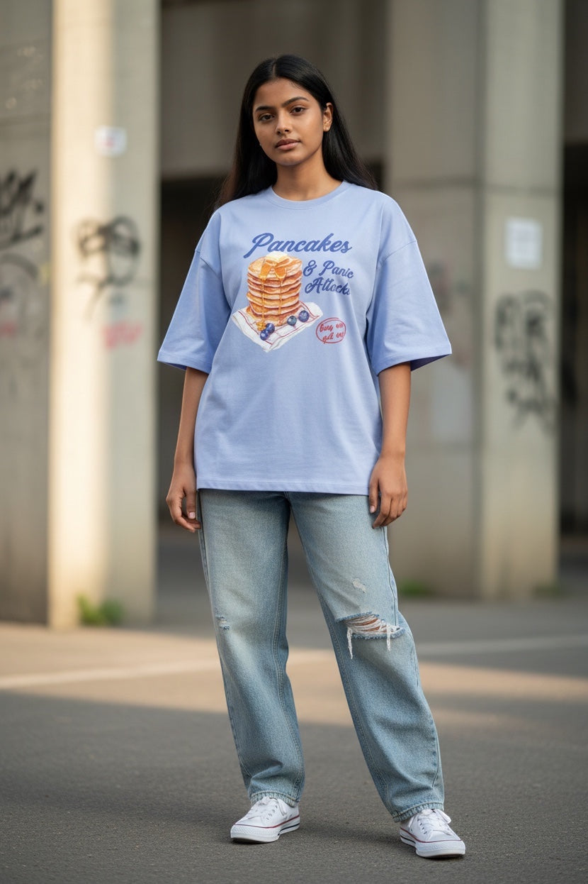 Frolic Saga light blue oversized 100% cotton French terry tee with "Pancake & Panic Attack" graphic print.