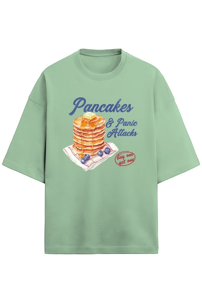 Frolic Saga light green oversized 100% cotton French terry t-shirt with "Pancakes & Panic Attack" graphic print.