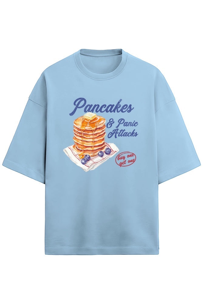 Frolic Saga light blue oversized French Terry cotton tee with "Pancakes & Panic Attack" graphic print.