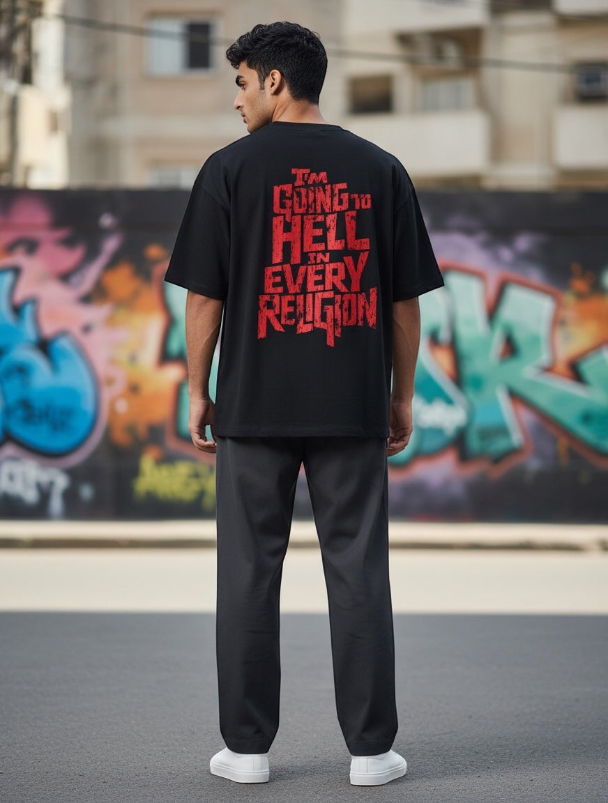 Frolic Saga black oversized cotton tee with distressed red typography graphic on back reading "I'M GOING TO HELL IN EVERY RELIGION".