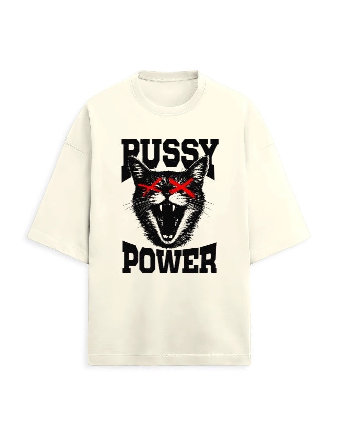Frolic Saga cream oversized tee with bold black graphic of a fierce cat with red X eyes and text Pussy Power.