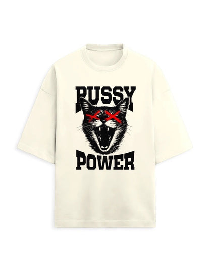 Frolic Saga cream oversized tee with bold black graphic of a fierce cat with red X eyes and text Pussy Power.
