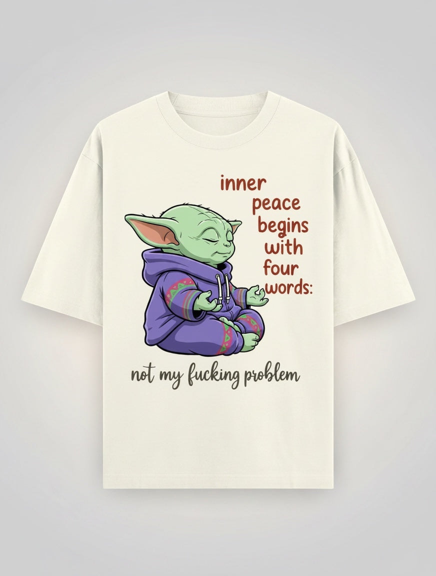 Frolic Saga cream 100% cotton oversized t-shirt with a graphic of Yoda meditating, wearing a purple hoodie, with text "inner peace begins with four words: not my fucking problem".