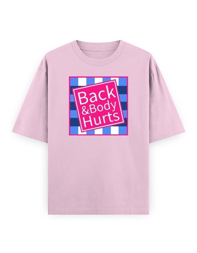 Frolic Saga oversized light pink 100% cotton t-shirt with a pink square graphic that says "Back & Body Hurts" on a blue and white checkered background.