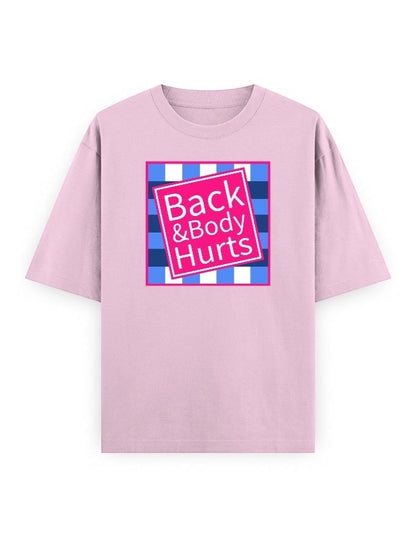 Frolic Saga oversized light pink 100% cotton t-shirt with a pink square graphic that says "Back & Body Hurts" on a blue and white checkered background.