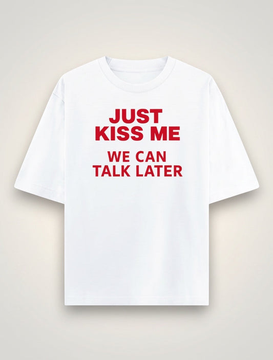 Frolic Saga Unisex oversized classic white 100% cotton t-shirt with red text graphic "JUST KISS ME WE CAN TALK LATER".