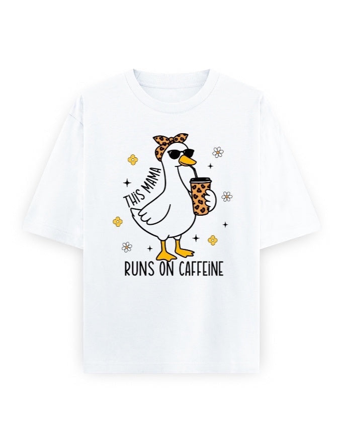 Frolic Saga white 100% cotton oversized t-shirt with a graphic of a duck wearing sunglasses and a leopard print bandana, holding a coffee cup. Text reads "THIS MAMA RUNS ON CAFFEINE."