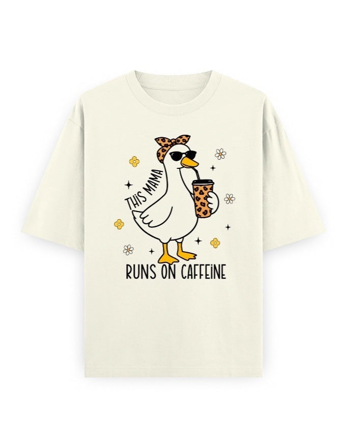 Frolic Saga cream 100% cotton oversized t-shirt with a graphic of a duck wearing sunglasses and a bandana, holding a coffee cup. Text reads "THIS MAMA RUNS ON CAFFEINE".