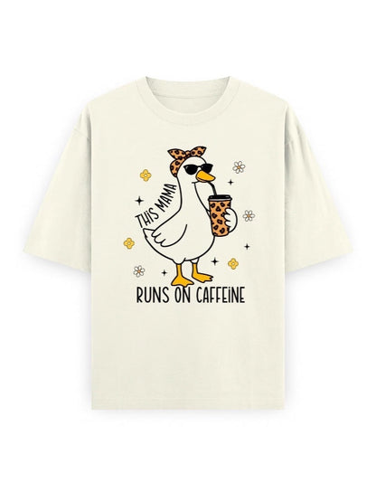 Frolic Saga cream 100% cotton oversized t-shirt with a graphic of a duck wearing sunglasses and a bandana, holding a coffee cup. Text reads "THIS MAMA RUNS ON CAFFEINE".