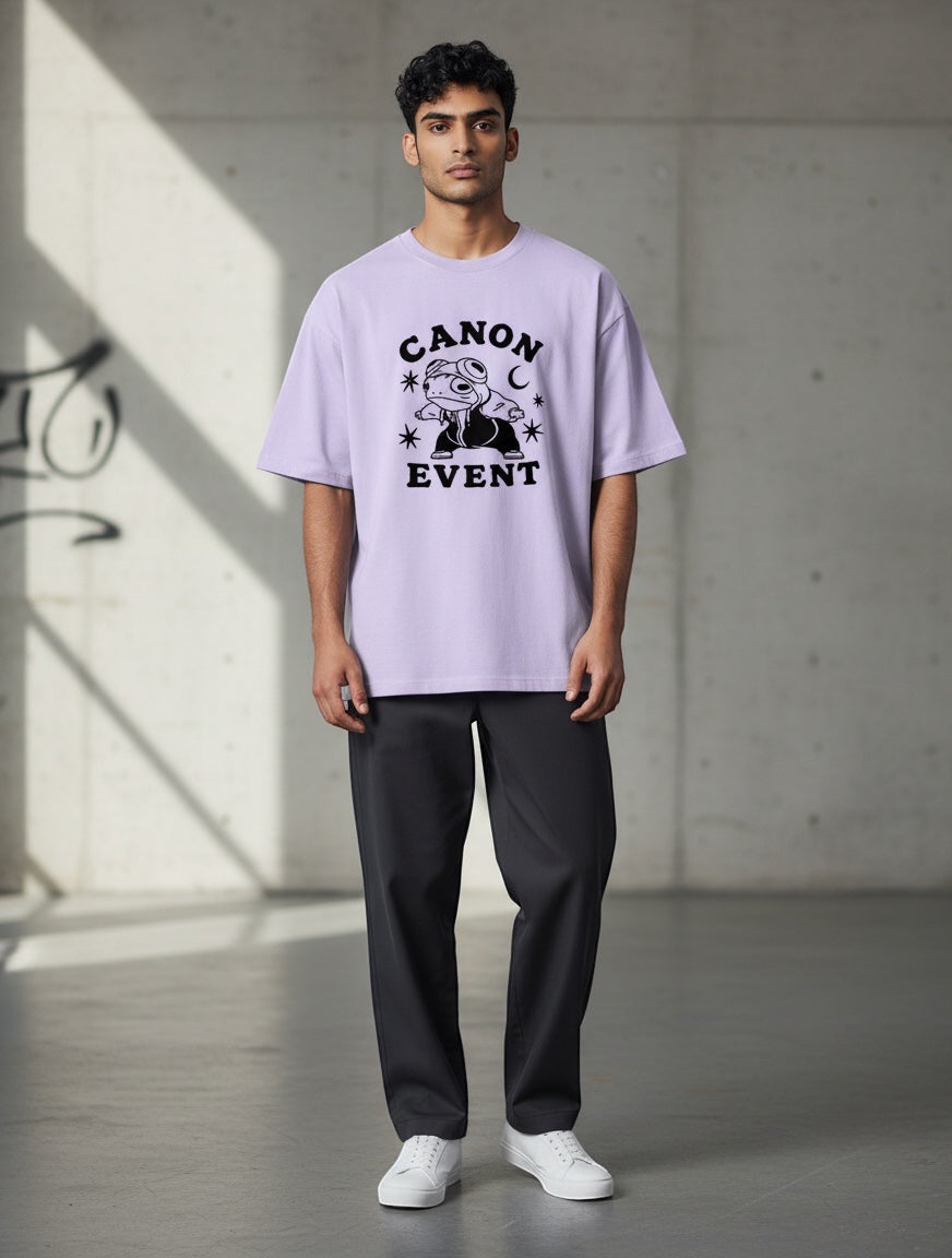 Frolic Saga Unisex oversized lavender 100% cotton t-shirt with "CANON EVENT" graphic print and dropped sleeves.