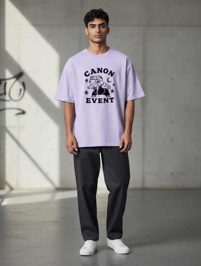 Frolic Saga Unisex oversized lavender 100% cotton t-shirt with "CANON EVENT" graphic print and dropped sleeves.