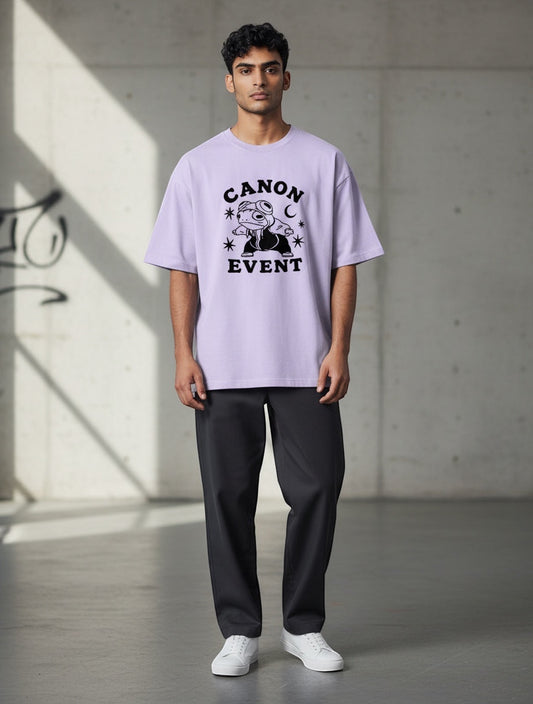 Frolic Saga Unisex oversized lavender 100% cotton t-shirt with "CANON EVENT" graphic print and dropped sleeves.