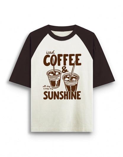 Cream and brown oversized raglan t-shirt featuring a dark brown graphic of two iced coffee cups and text that reads iced COFFEE & all day every day SUNSHINE.