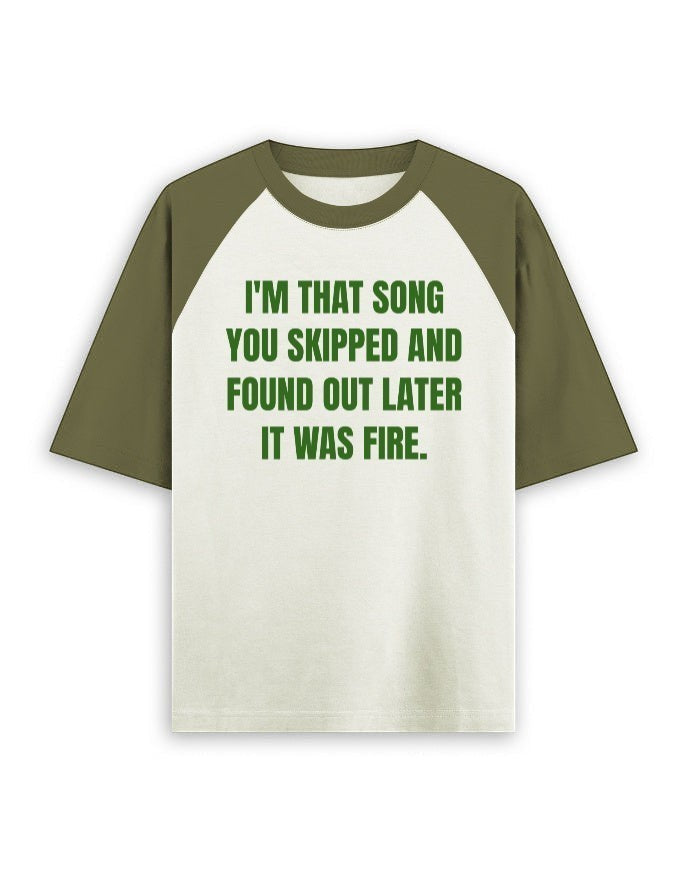 Frolic Saga unisex oversized raglan t-shirt in cream and olive green with a graphic print on the front.