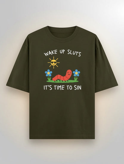 Frolic Saga olive green 100% cotton oversized t-shirt with a graphic print of a smiling worm, sun, and flowers, and text "WAKE UP SLUTS IT'S TIME TO SIN".