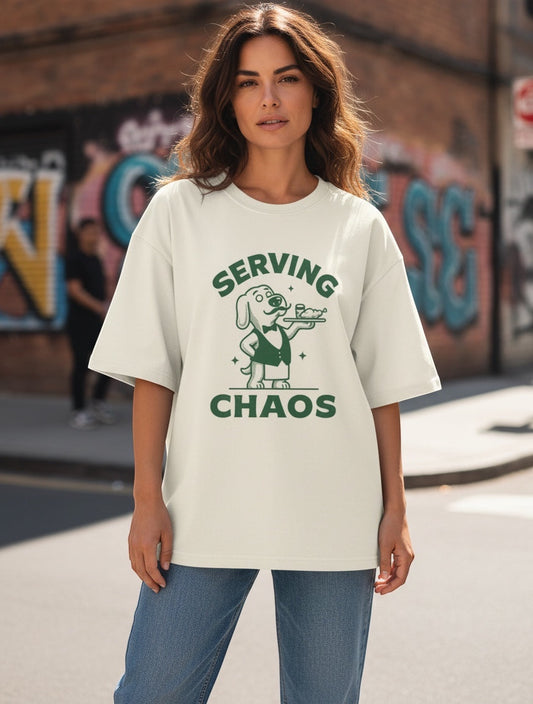 Frolic Saga Unisex oversized classic t-shirt in cream, 100% cotton with a dog graphic and "SERVING CHAOS" text.