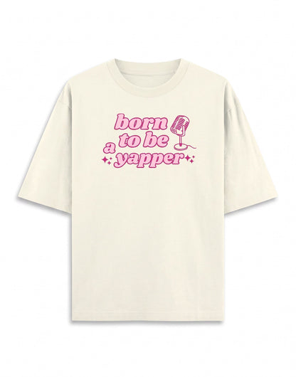Frolic Saga cream 100% cotton oversized t-shirt with pink "born to be a yapper" graphic and microphone.