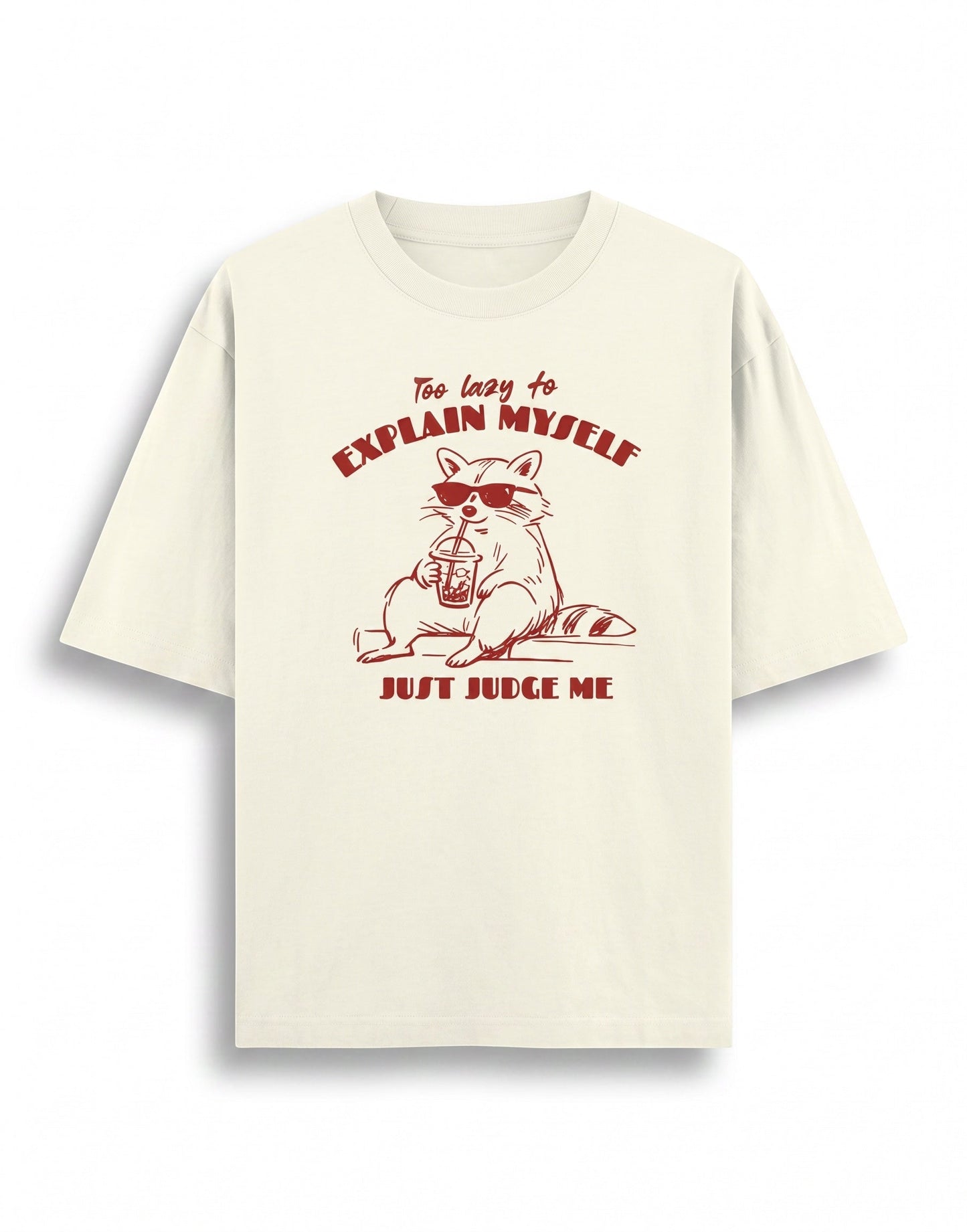 Frolic Saga unisex oversized classic t-shirt in cream, 100% cotton, with a raccoon graphic and text "Too lazy to explain myself, just judge me."