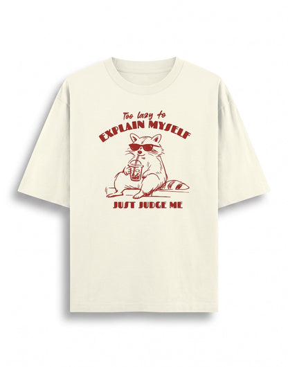 Frolic Saga unisex oversized classic t-shirt in cream, 100% cotton, with a raccoon graphic and text "Too lazy to explain myself, just judge me."