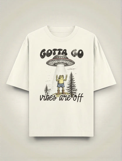 Frolic Saga cream 100% cotton oversized t-shirt with UFO abduction graphic and "Gotta Go Vibes Are Off" text.