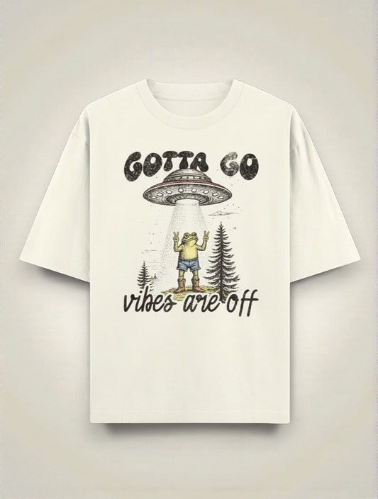 Frolic Saga cream 100% cotton oversized t-shirt with UFO abduction graphic and "Gotta Go Vibes Are Off" text.