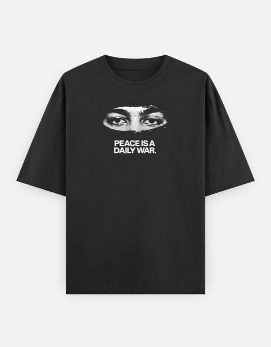 Peace Is A Daily War black oversized tee, front close-up eyes graphic with bold white typography - Frolic Saga