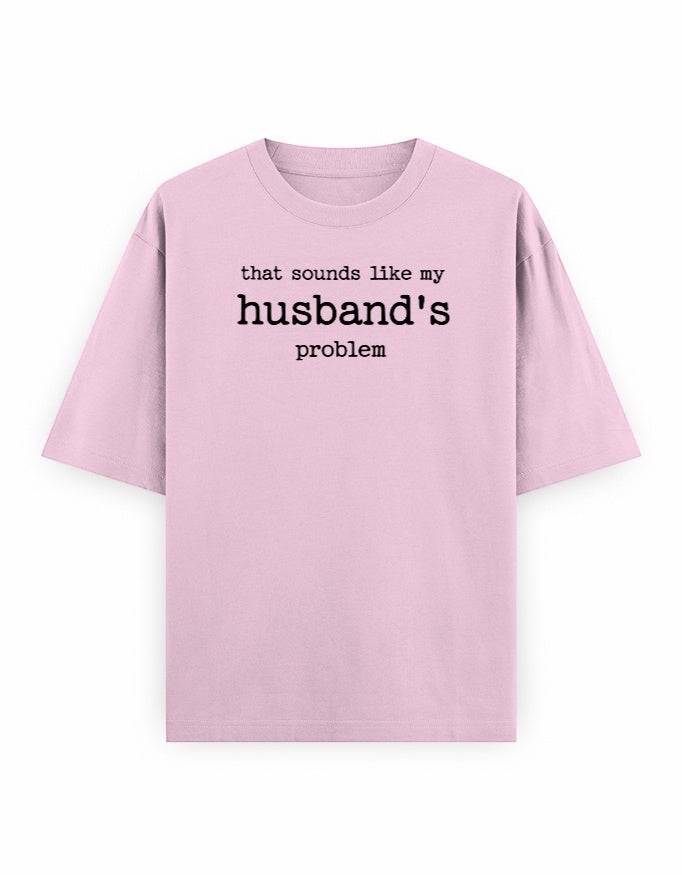 Frolic Saga light pink oversized 100% cotton t-shirt with black text graphic that says "that sounds like my husband's problem."