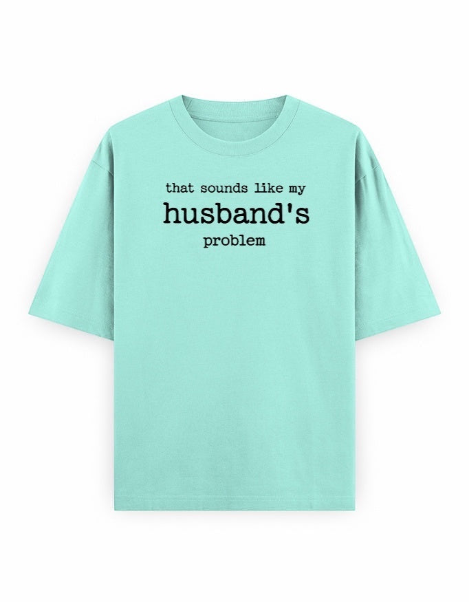 Frolic Saga light pink oversized 100% cotton t-shirt with black text graphic that says "that sounds like my husband's problem."
