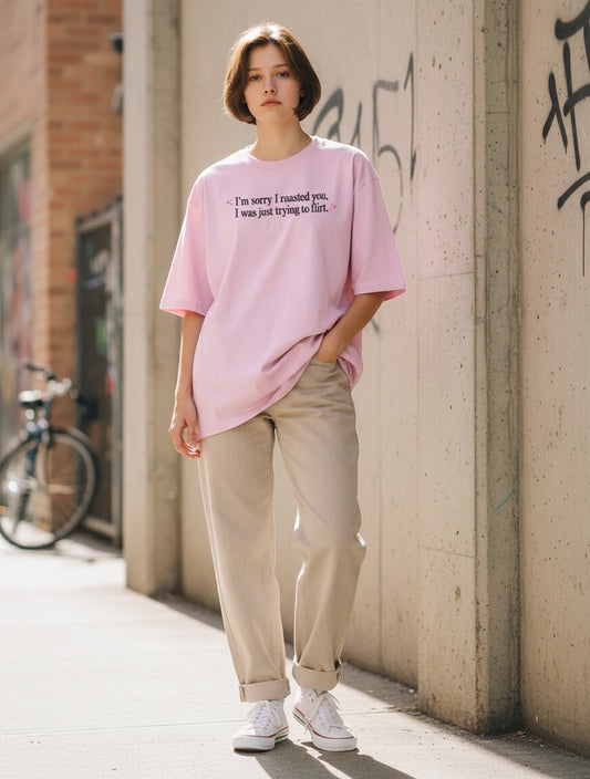 Frolic Saga pink oversized 100% cotton t-shirt with "I'm sorry I roasted you, I was just trying to flirt" graphic.