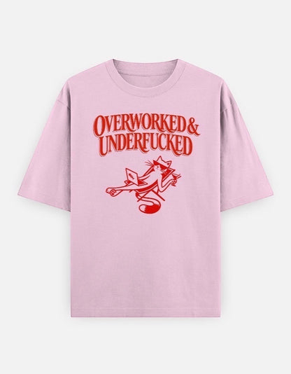 Frolic Saga light pink oversized cotton t-shirt with red graphic text "Overworked & Underfucked" and a cat illustration.