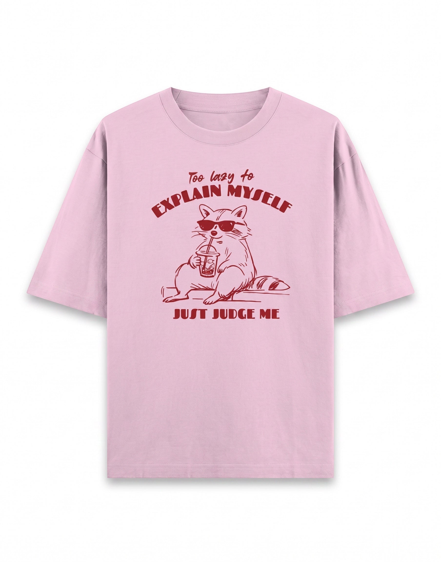 Frolic Saga pink 100% cotton oversized t-shirt with a graphic of a raccoon wearing sunglasses and holding a drink, text reads "Too lazy to explain myself JUST JUDGE ME."