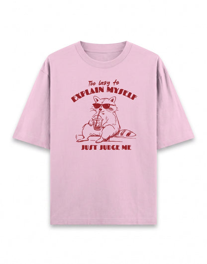 Frolic Saga pink 100% cotton oversized t-shirt with a graphic of a raccoon wearing sunglasses and holding a drink, text reads "Too lazy to explain myself JUST JUDGE ME."