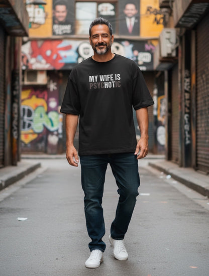 Frolic Saga black 100% cotton oversized graphic tee with "My Wife Is (HOT) Psychotic" illusion text.