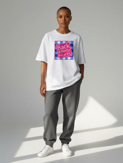 Frolic Saga white oversized 100% cotton t-shirt with "Back & Body Hurts" graphic print on a model.
