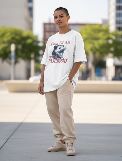 Frolic Saga white 100% cotton oversized t-shirt with a graphic print of a possum and text "First Of All I'M A Delight".