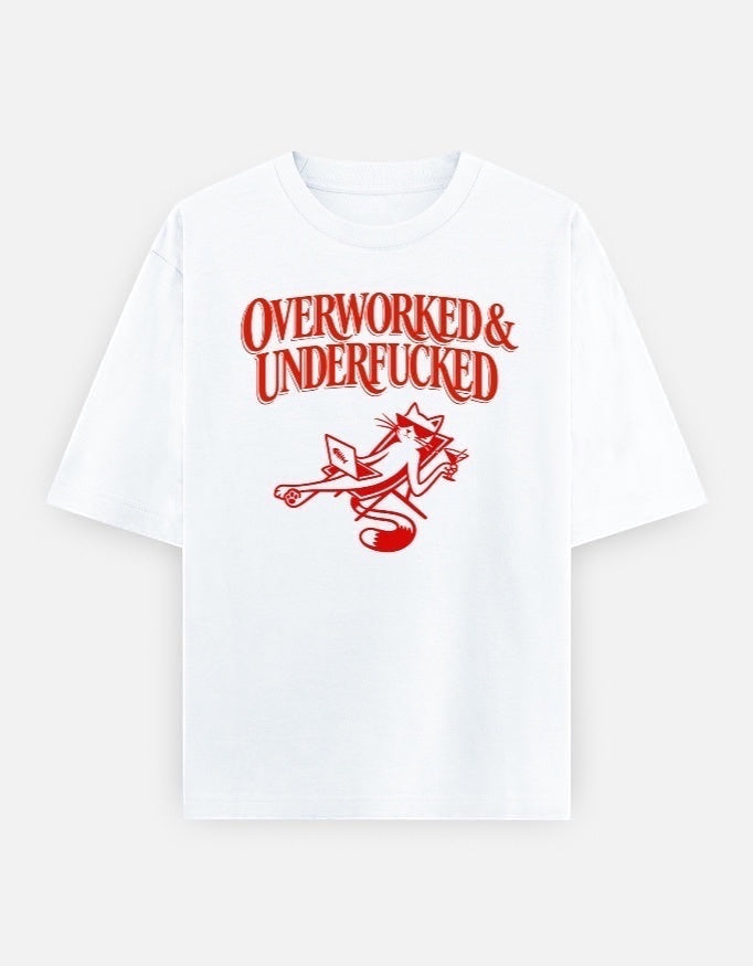 Frolic Saga white oversized cotton t-shirt with red graphic text "Overworked & Underfucked" and a cat illustration.