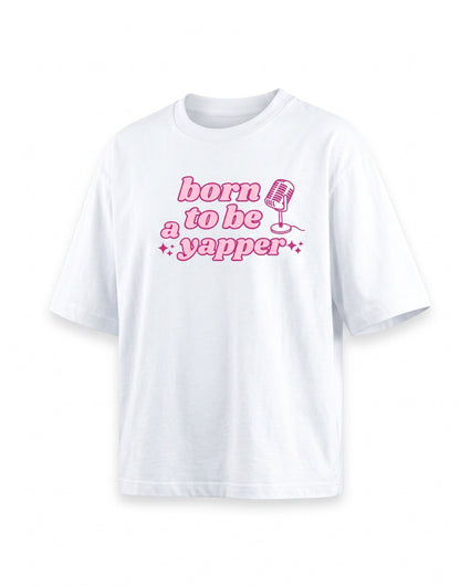 Frolic Saga white 100% cotton oversized t-shirt with pink "born to be a yapper" graphic and microphone design.